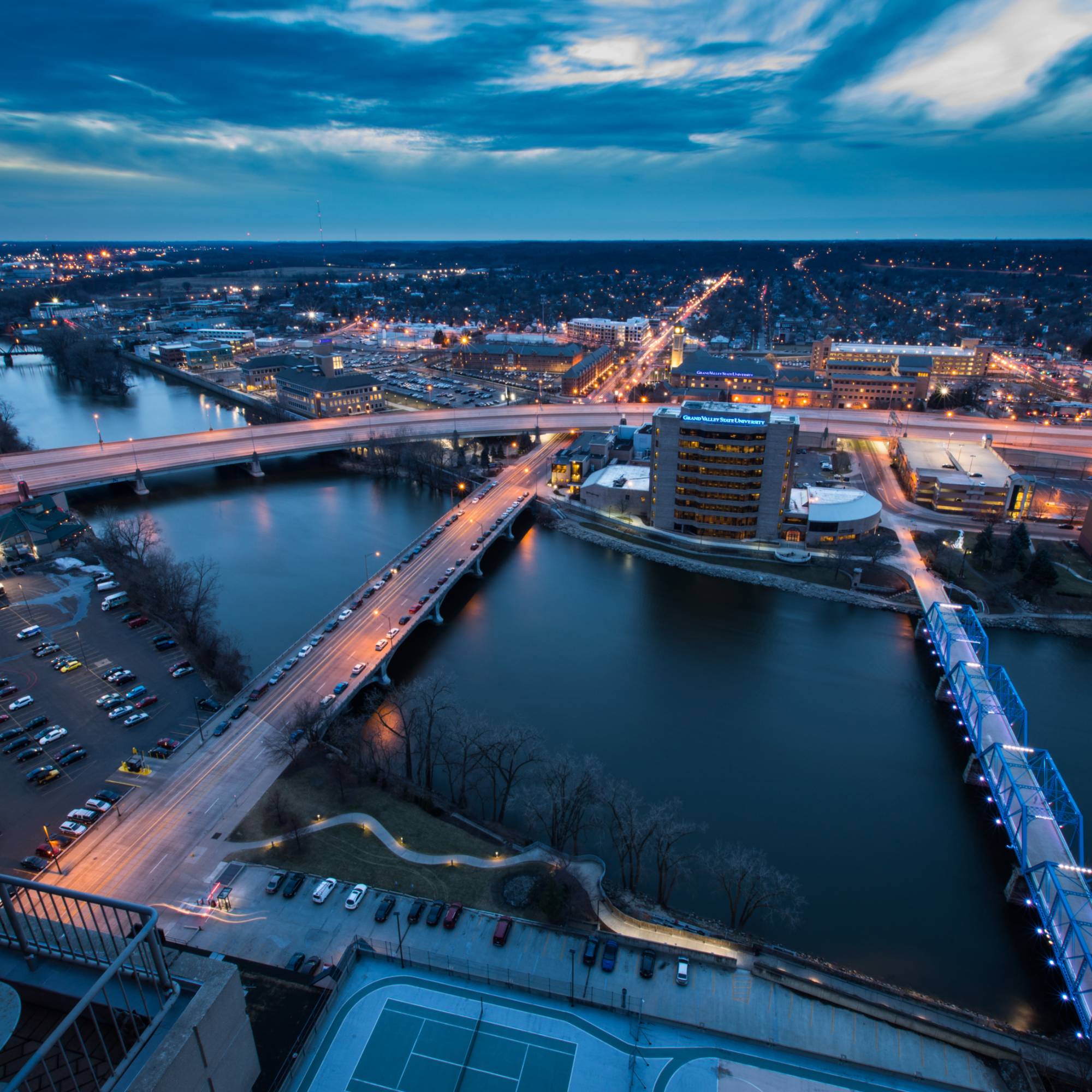 Nighttime, arial view of bridges crossing Grand River in Grand Rapids, MI